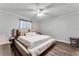 Bright bedroom with neutral walls, wood-look floors, a ceiling fan, and a king bed at 1234 Villa Ln # S, Apopka, FL 32712