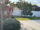 Fenced-in backyard featuring green grass, manicured bushes, and leafy trees at 12546 Britwell Ct, Orlando, FL 32837