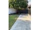 A concrete patio extends to a grassy backyard featuring privacy fences and a mature tree, creating a serene outdoor space at 12546 Britwell Ct, Orlando, FL 32837