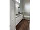 Bathroom featuring a double sink vanity with dark gray countertops and a tiled bathtub at 12546 Britwell Ct, Orlando, FL 32837