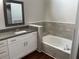 Bathroom with gray countertop, white vanity, tub and gray tile accents at 12546 Britwell Ct, Orlando, FL 32837