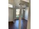 Dining area featuring hardwood flooring, decorative column, and a large window overlooking the yard at 12546 Britwell Ct, Orlando, FL 32837