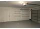 The garage is equipped with shelving for storage and an automatic door, adding convenience and functionality at 12546 Britwell Ct, Orlando, FL 32837