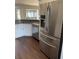 Stainless steel refrigerator and kitchen sink complimented by white cabinetry and gray countertops at 12546 Britwell Ct, Orlando, FL 32837