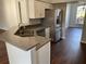 Kitchen featuring stainless steel sink, dishwasher, white cabinets and gray countertops at 12546 Britwell Ct, Orlando, FL 32837