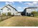 Wide view of the back of the house with a large green lawn and solar panels at 12849 Bovet Ave, Orlando, FL 32827