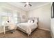 Cozy bedroom with neutral carpet, a ceiling fan, and a large window with plenty of natural light at 12849 Bovet Ave, Orlando, FL 32827