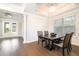 Elegant dining room with tray ceiling, modern chandelier, dark wood table, and four chairs at 12849 Bovet Ave, Orlando, FL 32827