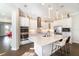 Gourmet kitchen featuring white cabinetry, stainless steel appliances, a large island, and pendant lighting at 12849 Bovet Ave, Orlando, FL 32827