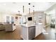 Bright, open kitchen featuring an island with white cabinets, stainless steel appliances, and pendant lighting at 12849 Bovet Ave, Orlando, FL 32827