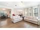 Bright and airy living room featuring modern sofas, hardwood floors, and a view into the dining area at 12849 Bovet Ave, Orlando, FL 32827