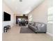 Open concept living room with tile floors, gray sofa, and view of kitchen island at 12849 Bovet Ave, Orlando, FL 32827