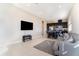 Spacious living room with a gray sofa, tile floors, and a view of the kitchen at 12849 Bovet Ave, Orlando, FL 32827