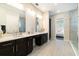 Main bathroom featuring double vanity sinks, a glass shower and views to the main bedroom at 12849 Bovet Ave, Orlando, FL 32827