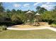 Community playground with slides, climbing structures, and shaded seating areas at 12849 Bovet Ave, Orlando, FL 32827