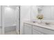 Bright bathroom featuring double vanity with quartz countertops and neutral tile floors at 132 Adventure Ave, Davenport, FL 33837