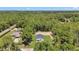 Overhead view of a modern home surrounded by lush green trees and landscaping at 13457 Sw 53Rd St, Ocala, FL 34481