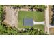 An aerial view of the home shows it's position on a grass lot, near a sandy plot at 13457 Sw 53Rd St, Ocala, FL 34481