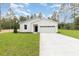 Charming one-story home featuring a well-manicured lawn, attached two car garage, and modern curb appeal at 13457 Sw 53Rd St, Ocala, FL 34481