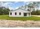 The home's exterior view features a freshly cut lawn, and a white facade at 13457 Sw 53Rd St, Ocala, FL 34481
