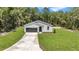 New construction home with a gray exterior, an attached garage, and a concrete driveway at 13457 Sw 53Rd St, Ocala, FL 34481