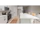 Contemporary kitchen with white cabinets, stainless steel appliances, and a spacious quartz center island at 13457 Sw 53Rd St, Ocala, FL 34481