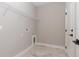 Clean and bright laundry room with neutral wall paint and wood-look tile flooring at 13457 Sw 53Rd St, Ocala, FL 34481