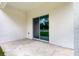 View of the concrete patio, showcasing the sliding glass door that provides seamless access to the home at 13457 Sw 53Rd St, Ocala, FL 34481