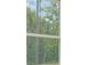 A bright window offering views of the property's green and wooded exterior at 13457 Sw 53Rd St, Ocala, FL 34481
