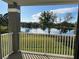 Balcony view overlooking a serene lake and lush green landscape, framed by a white railing at 13929 Fairway Island Dr # 822, Orlando, FL 32837