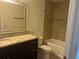 Bathroom featuring a shower/tub combo, granite countertop and large mirror at 13929 Fairway Island Dr # 822, Orlando, FL 32837