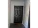 A simple black front door with a knocker and unit number 822. The door has rectangular indents for design at 13929 Fairway Island Dr # 822, Orlando, FL 32837