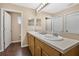 Bright bathroom with a double sink vanity and large mirrors offering a refreshing space at 1613 Priory Cir, Winter Garden, FL 34787