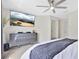 Stylish bedroom with ceiling fan, a wall-mounted TV, dresser, and a cozy throw at 1613 Priory Cir, Winter Garden, FL 34787