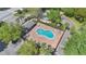 Aerial view of a kidney-shaped pool with lounge chairs, a picnic table, and a covered area at 1613 Priory Cir, Winter Garden, FL 34787