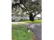 Charming condo building in a golf community, featuring lush landscaping and mature trees at 220 N Idlewood Ave # 203, Bartow, FL 33830