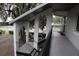 Exterior view of a two-story condo building with an open air staircase and mature trees at 220 N Idlewood Ave # 203, Bartow, FL 33830