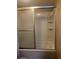 A clean tiled shower features a detachable shower head, silver faucet, and built-in shelving at 220 N Idlewood Ave # 203, Bartow, FL 33830