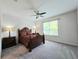 Cozy bedroom with soft carpet, a ceiling fan, and a large window with natural light at 225 Vestrella Dr, Kissimmee, FL 34759