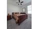 Bedroom with wood furniture, ceiling fan, and carpeted floors offers a calming retreat at 225 Vestrella Dr, Kissimmee, FL 34759