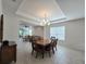 Bright dining room with tray ceiling and chandelier, open to the living area at 225 Vestrella Dr, Kissimmee, FL 34759