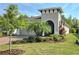 Landscaped front yard of a single-story home with brick paver driveway and tropical plants at 225 Vestrella Dr, Kissimmee, FL 34759