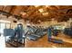 Gym with wooden floors, vaulted wood beam ceilings and rows of treadmills and exercise equipment at 225 Vestrella Dr, Kissimmee, FL 34759