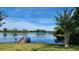 Community lake with a dock and a canoe has blue skies and calm waters with trees surrounding it at 225 Vestrella Dr, Kissimmee, FL 34759