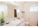 Bright bathroom with a large mirror, fresh towels, and natural light from an arched window at 252 Julliard Blvd, Davenport, FL 33897