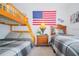 A bedroom featuring a bunk bed and another twin bed with plaid bedding at 252 Julliard Blvd, Davenport, FL 33897