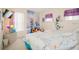 Bright bedroom featuring twin beds, window with blinds, and Frozen themed decor at 252 Julliard Blvd, Davenport, FL 33897