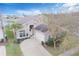 An aerial view of a charming two-story home showcasing the surrounding landscaping, driveway, and nearby pond at 252 Julliard Blvd, Davenport, FL 33897