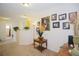 Spacious hallway features a decorative table and an assortment of framed Gathering photos at 252 Julliard Blvd, Davenport, FL 33897