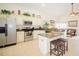 A modern kitchen with stainless steel appliances, granite countertops, and an adjacent living area at 252 Julliard Blvd, Davenport, FL 33897